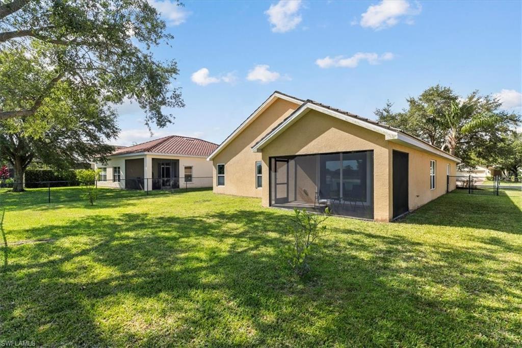2806 Orange Grove Trail Naples, FL 34120 - Photo 17 of 24 a front view of house with yard and green space