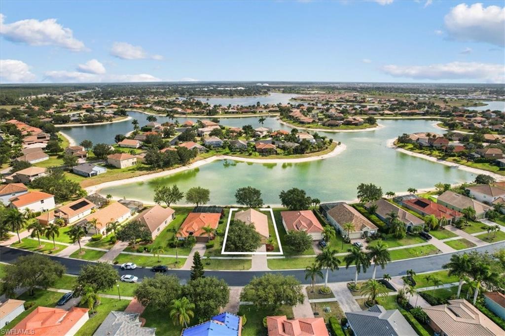 2806 Orange Grove Trail Naples, FL 34120 - Photo 20 of 24 an aerial view of residential building and lake