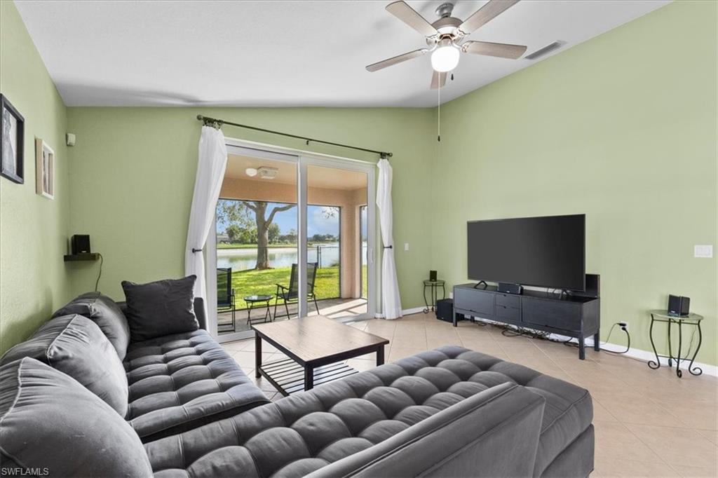 2806 Orange Grove Trail Naples, FL 34120 - Photo 7 of 24 a living room with furniture and a flat screen tv