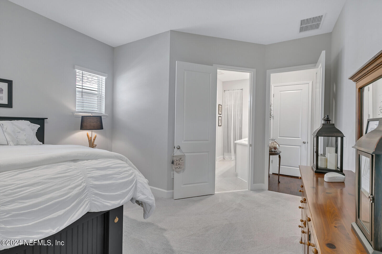 223 Chalet Ct Street St. Augustine, FL 32092 - Photo 21 of 45 a bedroom with a bed and a mirror