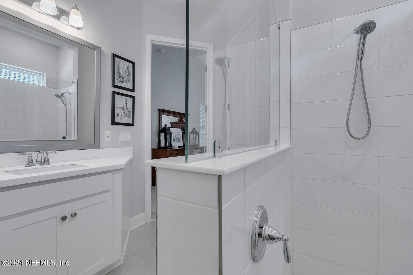 223 Chalet Ct Street St. Augustine, FL 32092 - Photo 23 of 45 a bathroom with a granite countertop sink a mirror and shower