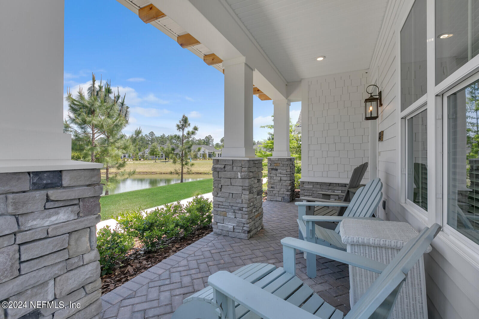 223 Chalet Ct Street St. Augustine, FL 32092 - Photo 6 of 45 a view of a patio with couches chairs potted plants and water view