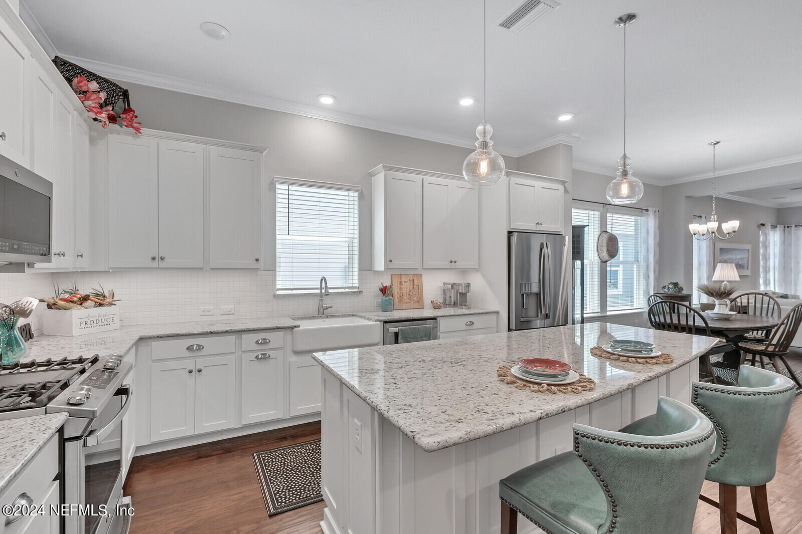 223 Chalet Ct Street St. Augustine, FL 32092 - Photo 7 of 45 a kitchen with a stove a refrigerator and a dining table