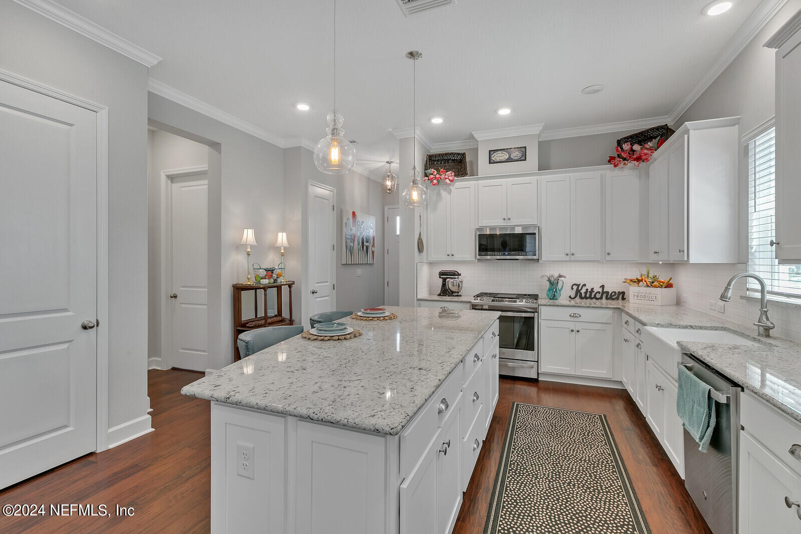 223 Chalet Ct Street St. Augustine, FL 32092 - Photo 8 of 45 a large kitchen with kitchen island a sink stove and refrigerator
