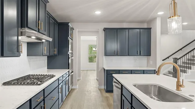 a kitchen with a sink stove and refrigerator
