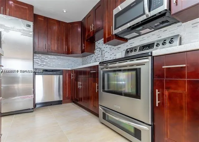 a kitchen with granite countertop a stove and a microwave