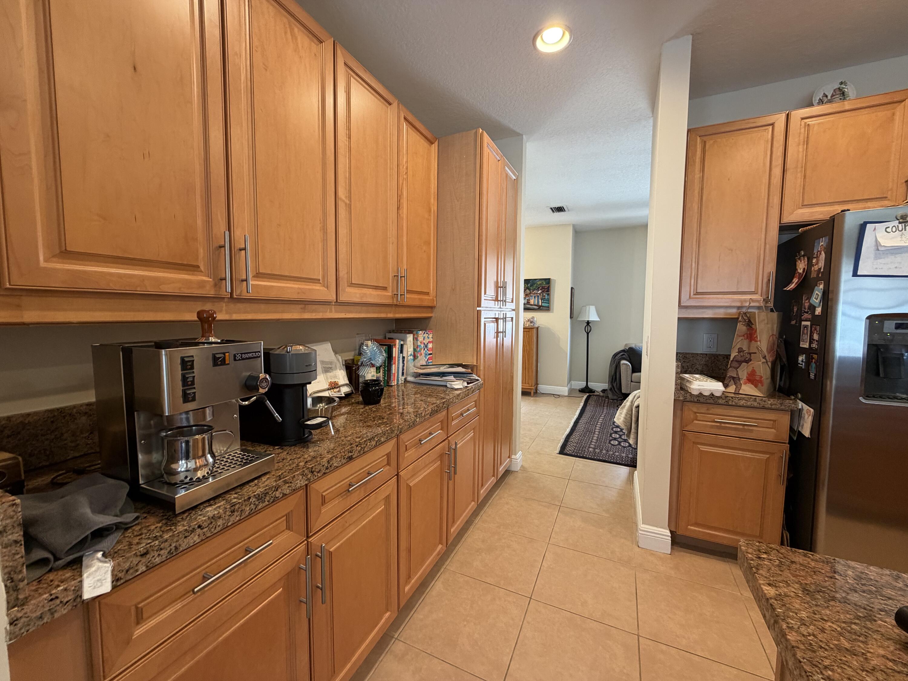 558 North West 39th Circle Boca Raton, FL 33431 - Photo 11 of 25 a kitchen with sink a refrigerator and cabinets