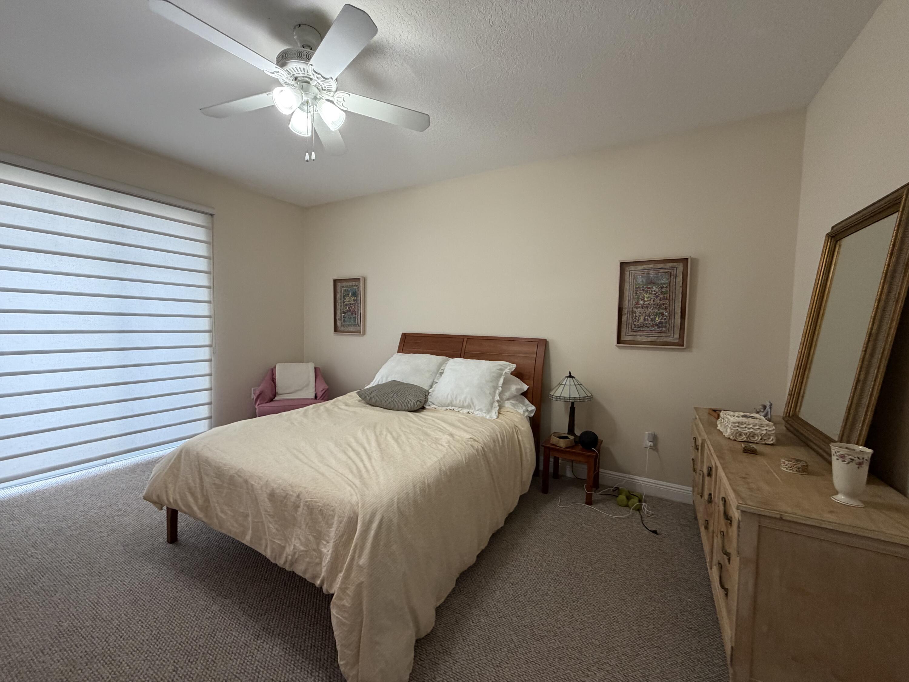 558 North West 39th Circle Boca Raton, FL 33431 - Photo 17 of 25 a bedroom with a bed desk and a window