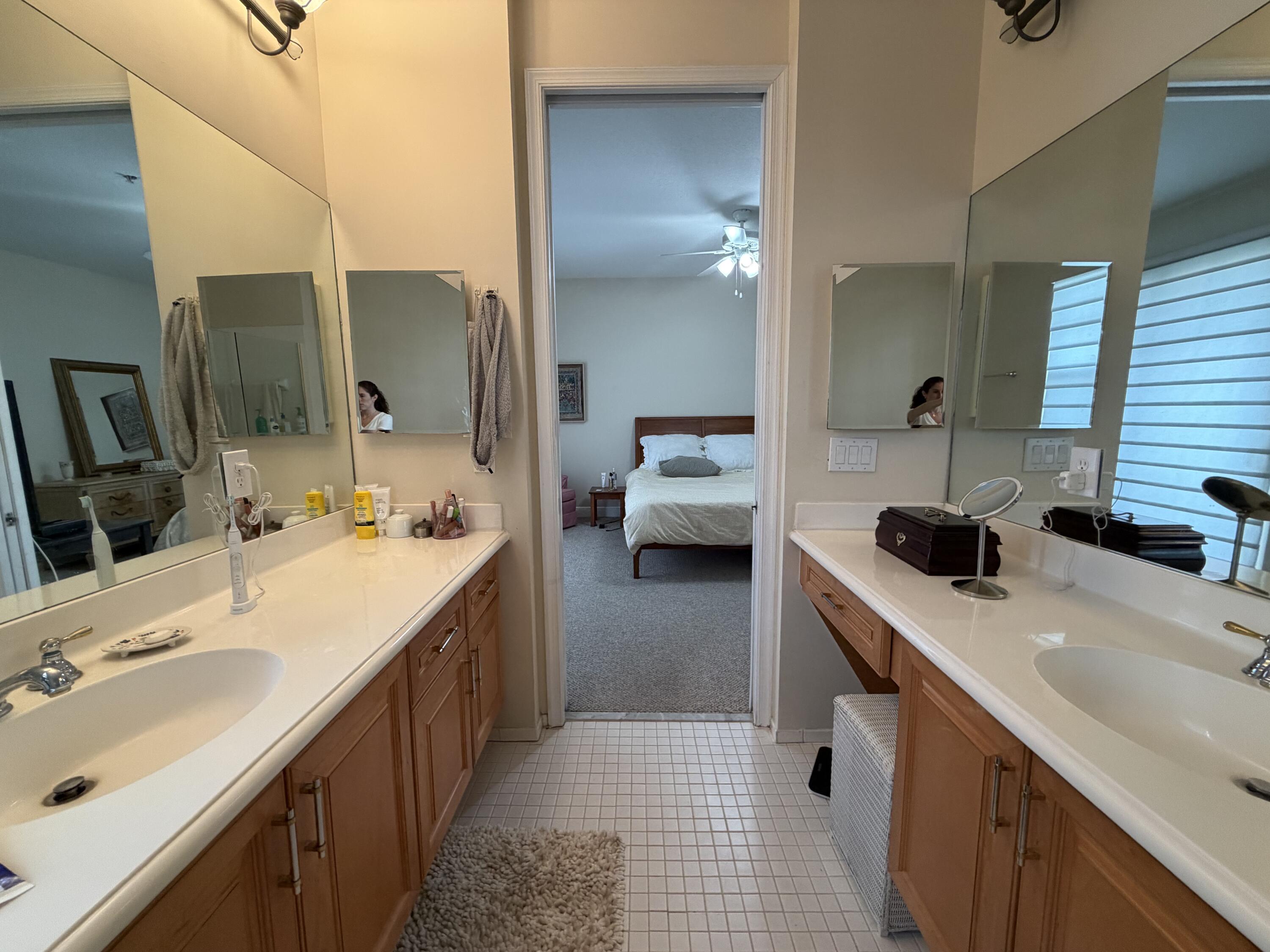 558 North West 39th Circle Boca Raton, FL 33431 - Photo 20 of 25 a bathroom with a sink double vanity and a mirror