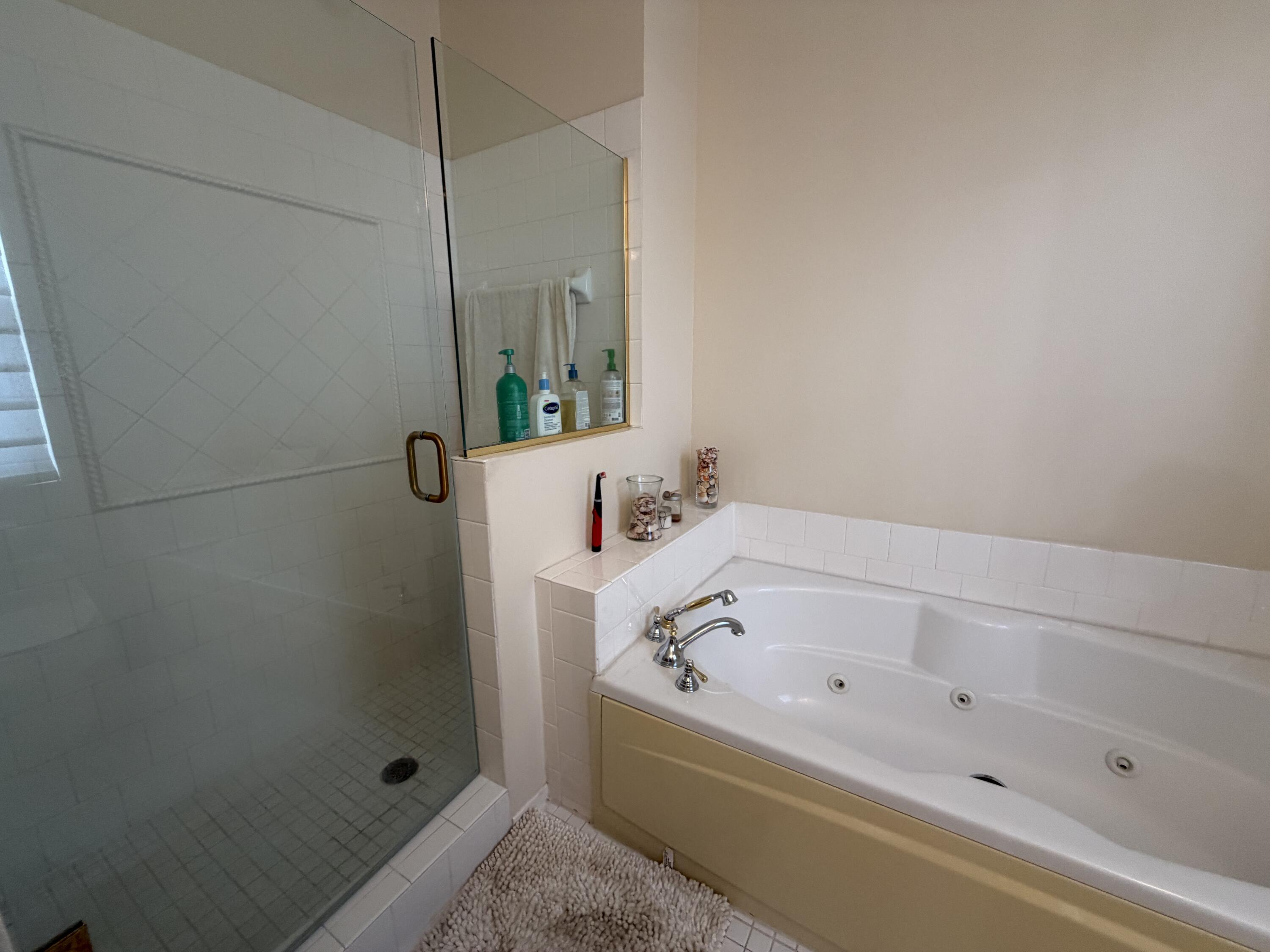 558 North West 39th Circle Boca Raton, FL 33431 - Photo 21 of 25 a bathroom with a bathtub and shower