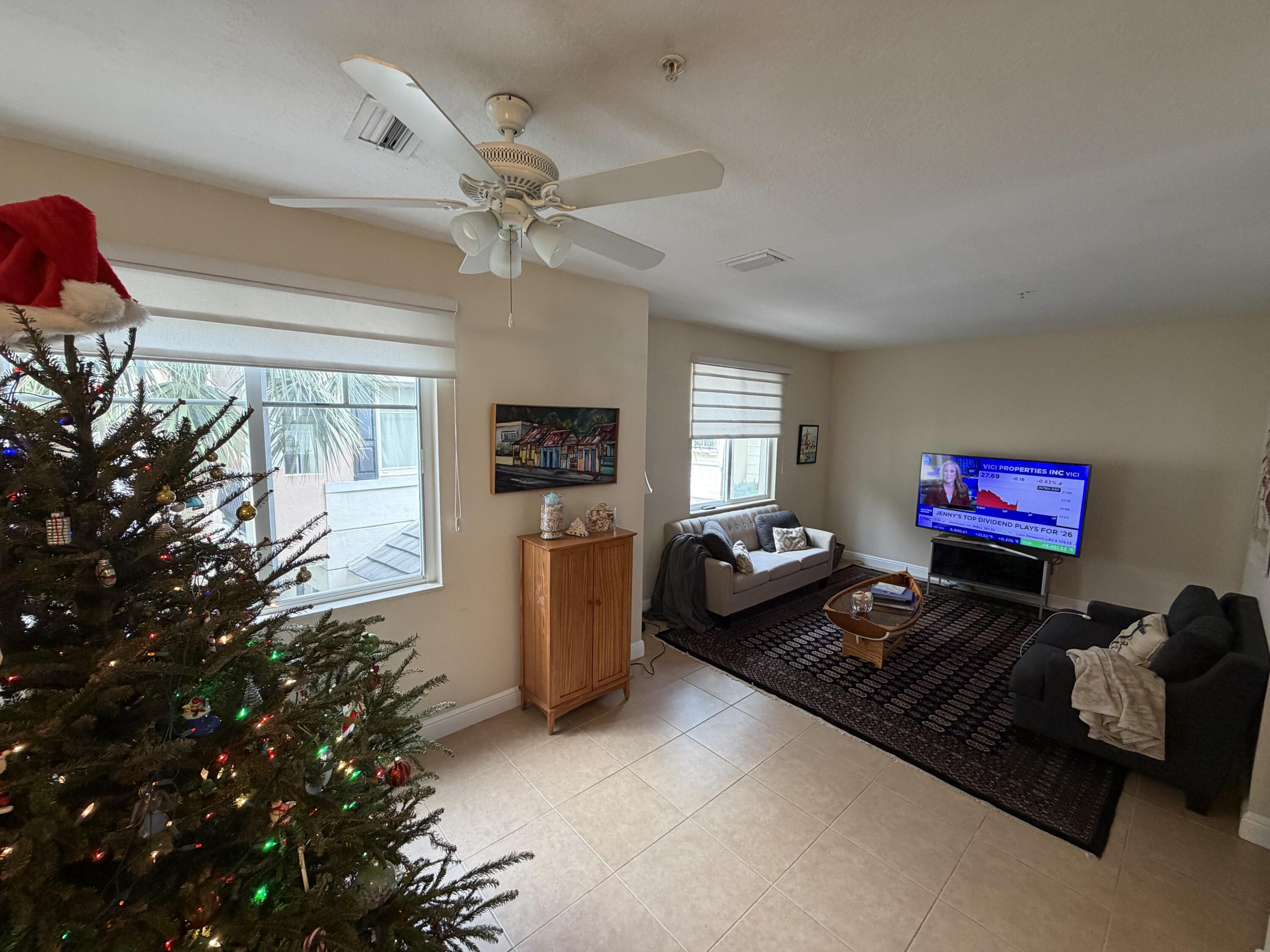 558 North West 39th Circle Boca Raton, FL 33431 - Photo 7 of 25 a living room with furniture a window and a flat screen tv