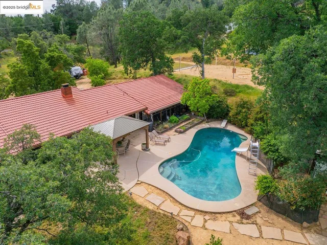 a backyard of a house with a yard and outdoor seating