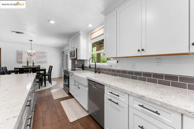 a kitchen with counter top space sink and stove