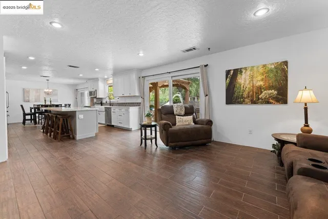 a living room with furniture and a kitchen