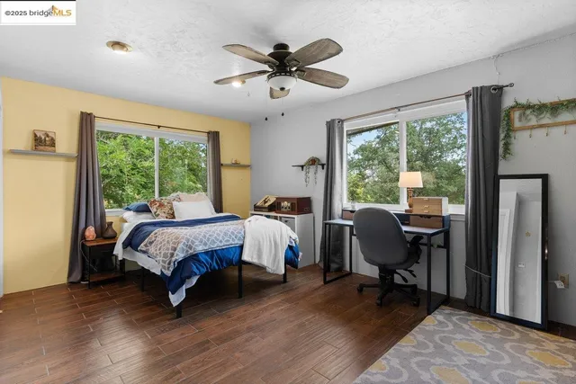 a bed room with a bed and a chair