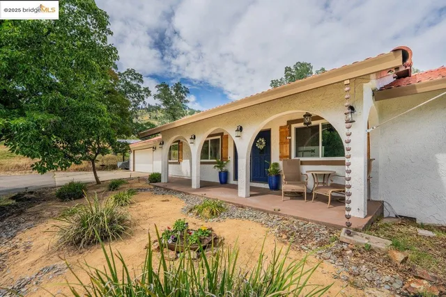 a front view of a house with a yard outdoor seating and pathway