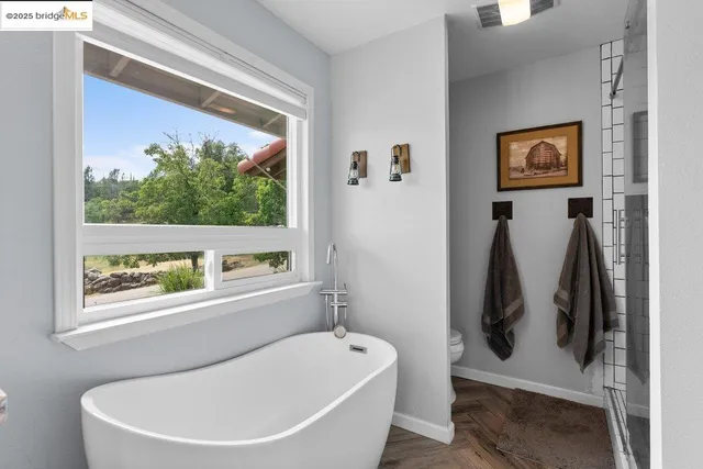 a bathroom with a tub and a window