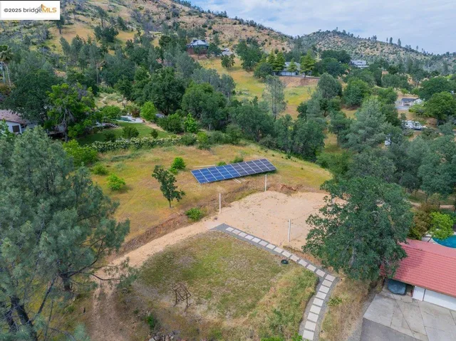 an aerial view of a house with outdoor space and a lake view