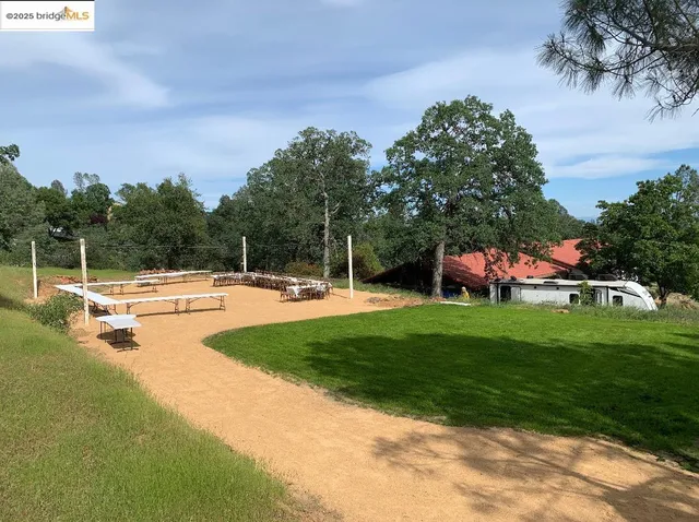 a view of a swimming pool with a yard and sitting area