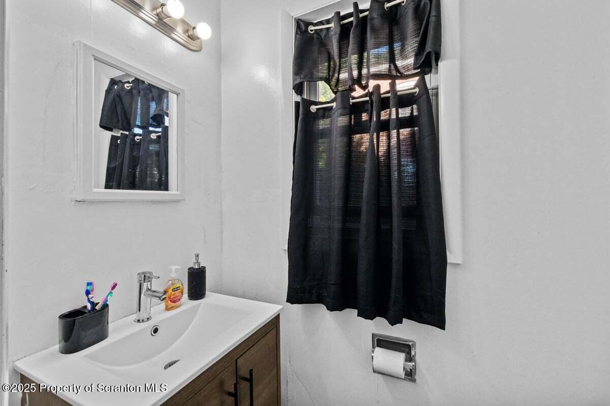 120 Ridgeway Street East Stroudsburg, PA 18301 - Photo 14 of 49 a bathroom with a sink vanity and a mirror