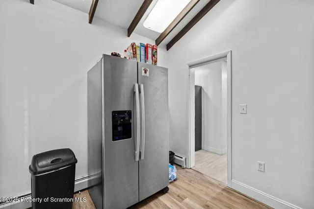 a kitchen with stainless steel appliances granite countertop a sink dishwasher and cabinets with wooden floor