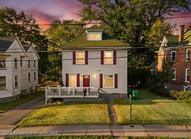 a house that has a tree in front of it