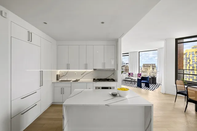 a living room with furniture and floor to ceiling windows