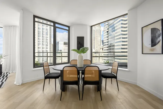 a kitchen with a sink a stove and white cabinets
