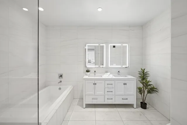 a bedroom with a bed and a couch next to a window