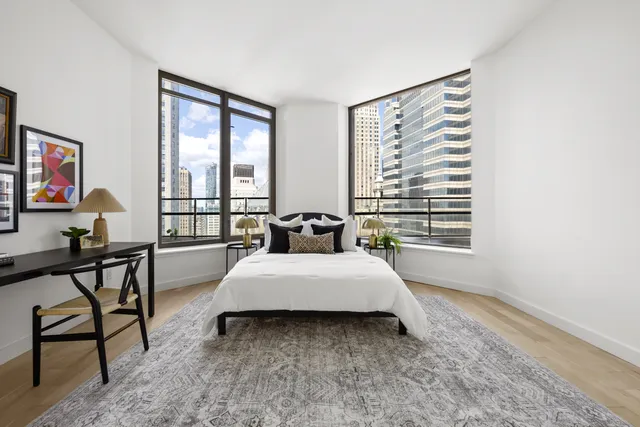 a spacious bathroom with a tub sink and mirror