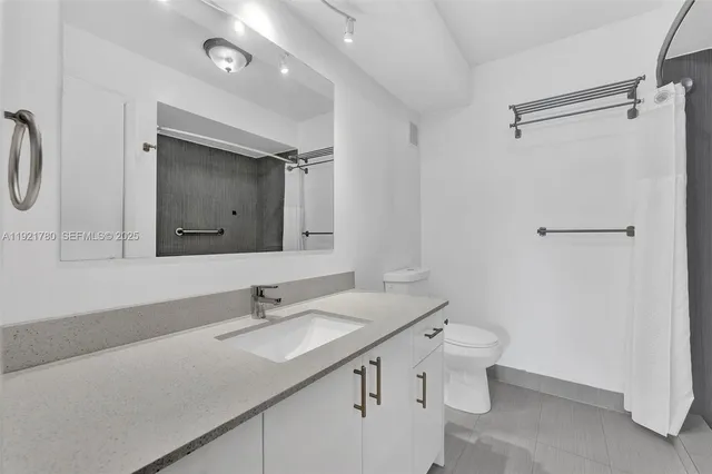 a bathroom with a sink double vanity and a mirror