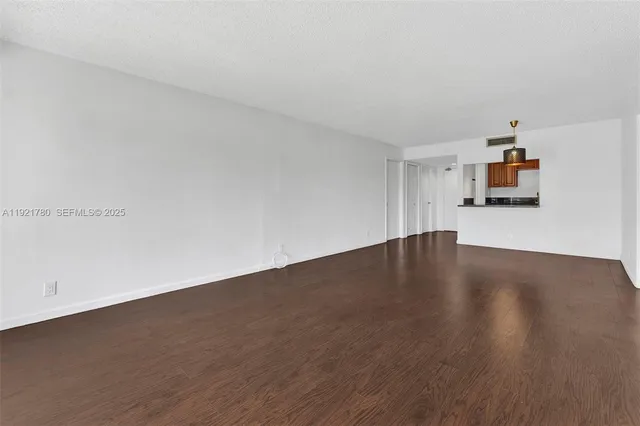 a view of a kitchen with wooden floor and a sink