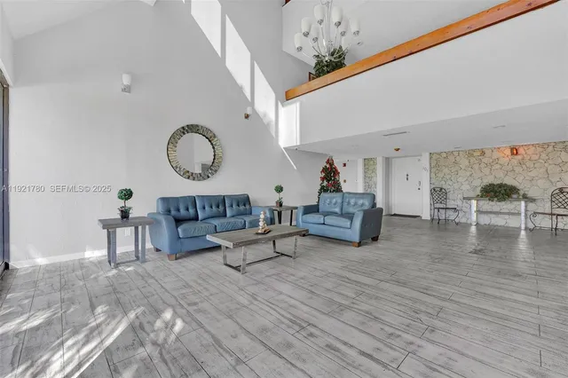 a living room with furniture and a chandelier