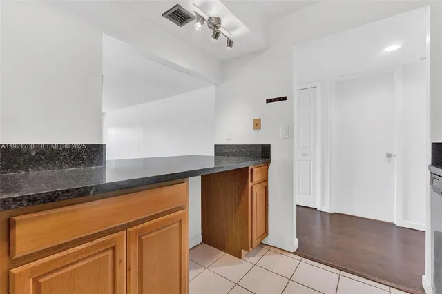 a view of a kitchen with closet and electronic appliances