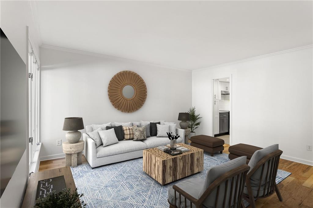 a living room with furniture and a large mirror next to a window