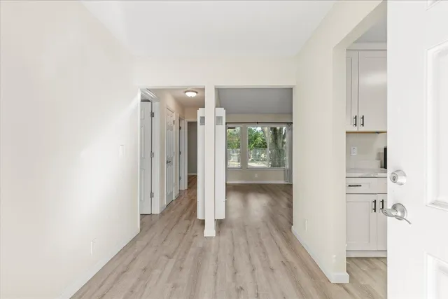 a view of a hallway with wooden floor