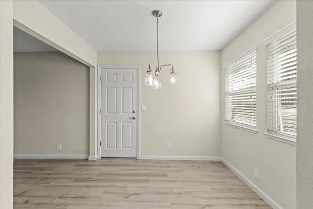a view of a room with wooden floor and windows