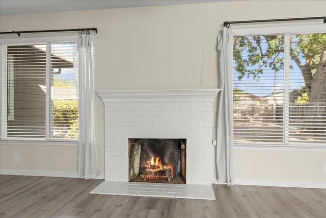 a living room with a fireplace and a window
