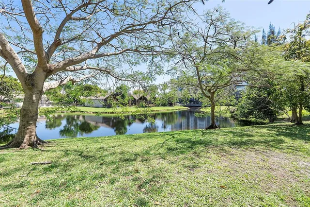 a view of lake with a big yard
