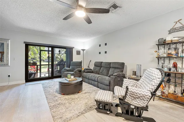 a living room with furniture a couch and a potted plant