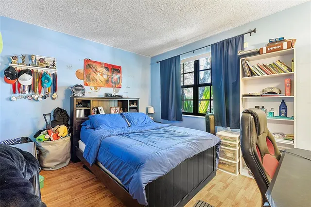 a bed sitting in a bedroom next to a window