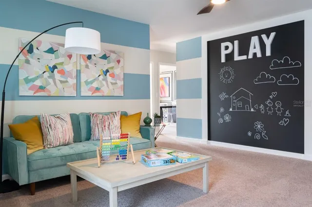 a living room with furniture and wall paintings