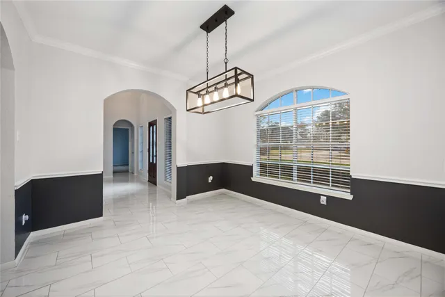 a view of an empty room with a chandelier