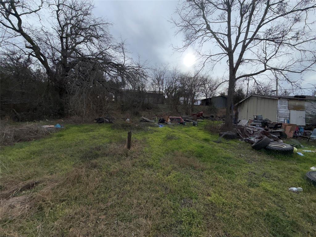 600 East Pierson Street Hamilton, TX 76531 - Photo 4 of 5 a view of a backyard with table and chairs and a fire pit
