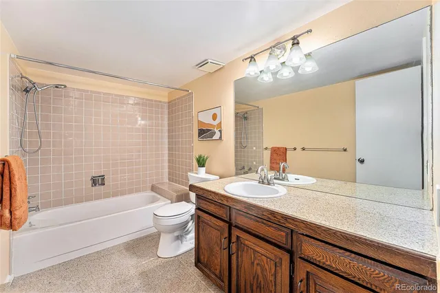 a bathroom with a sink a large mirror and a toilet