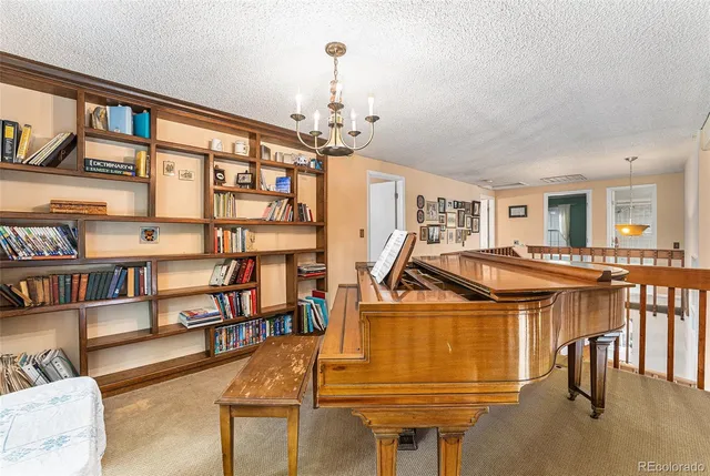 a living room with furniture a dining table and a bookshelf