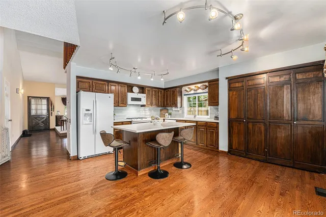 a view of a livingroom with furniture and a kitchen