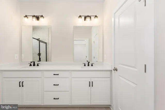 a bathroom with a double vanity sink and mirror