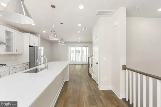 a bathroom with a sink a large mirror and a shower