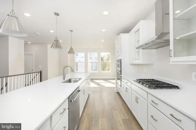 a kitchen with stainless steel appliances kitchen island granite countertop a sink and cabinets